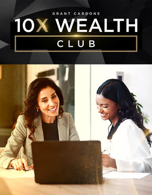Dedicated Cardone Wealth Certified Financial Planner mentoring a client at the computer, both smiling during a 10X Wealth Club session with Grant Cardone branding.
