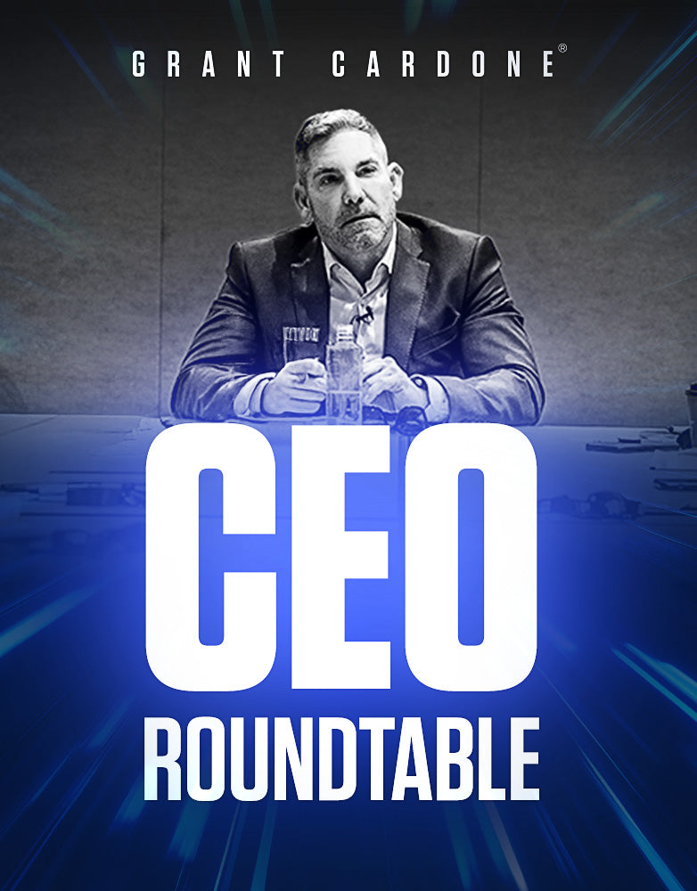 Grant Cardone seated at a conference table, listening attentively during the CEO Roundtable. Wearing a blazer with a water bottle on the table, surrounded by high-level business leaders, highlighting the exclusive Grant Cardone CEO Roundtable experience