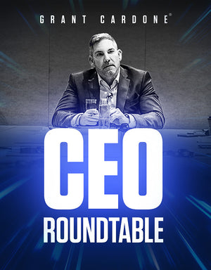 Grant Cardone seated at a conference table, listening attentively during the CEO Roundtable. Wearing a blazer with a water bottle on the table, surrounded by high-level business leaders, highlighting the exclusive Grant Cardone CEO Roundtable experience